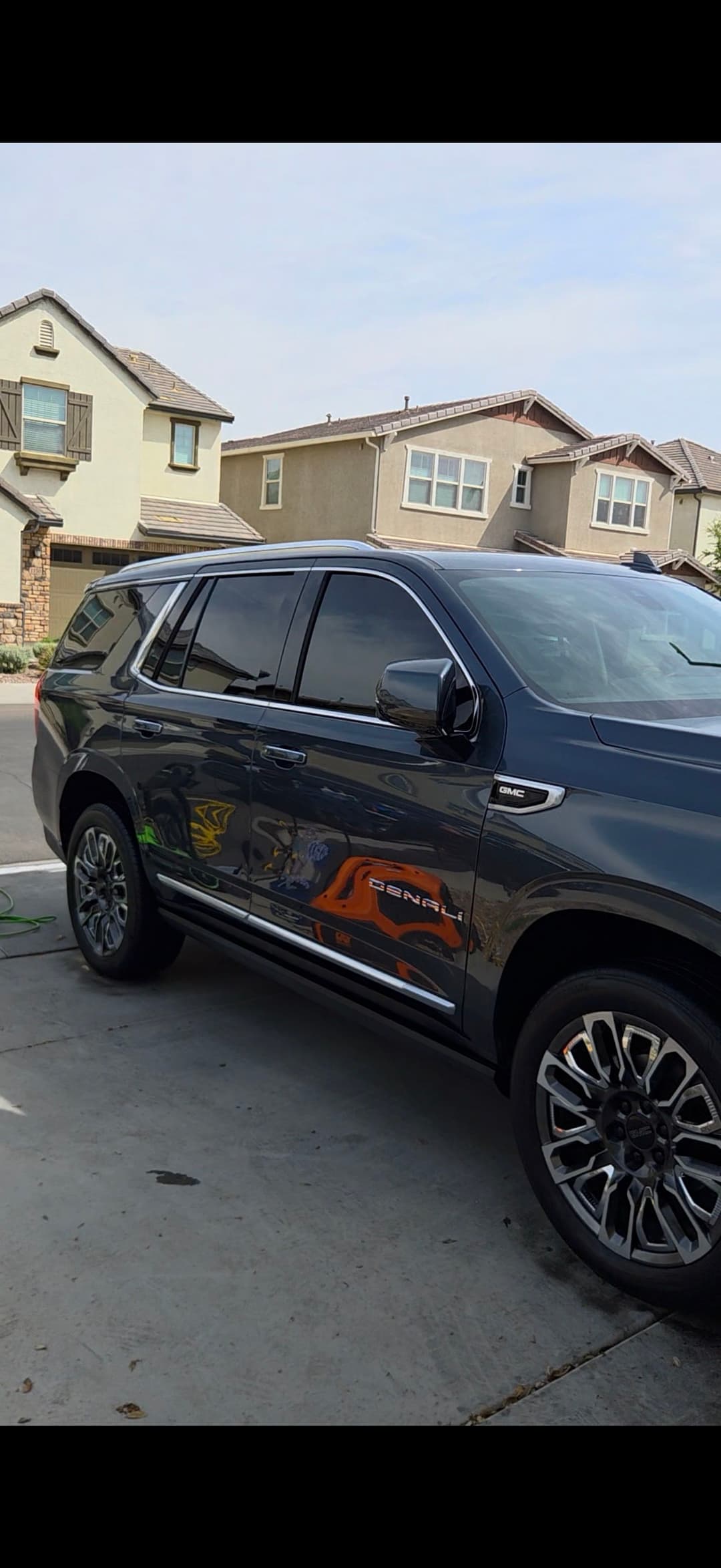 Blue GMC Terrain parked in a driveway, showcasing its sleek design and modern features.