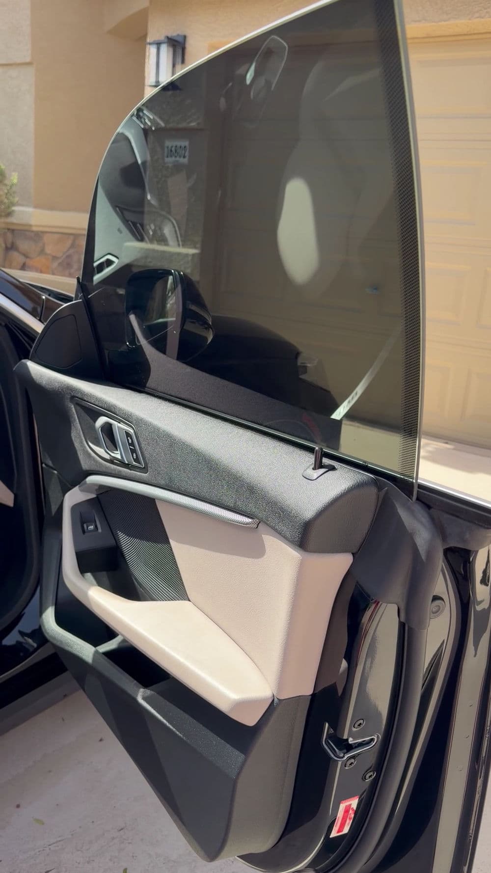 Close-up of car door interior featuring sleek design and modern materials.