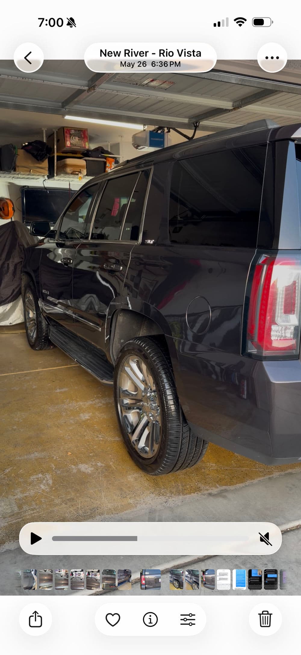 Black SUV parked in a garage with glossy wheels and a modern design.