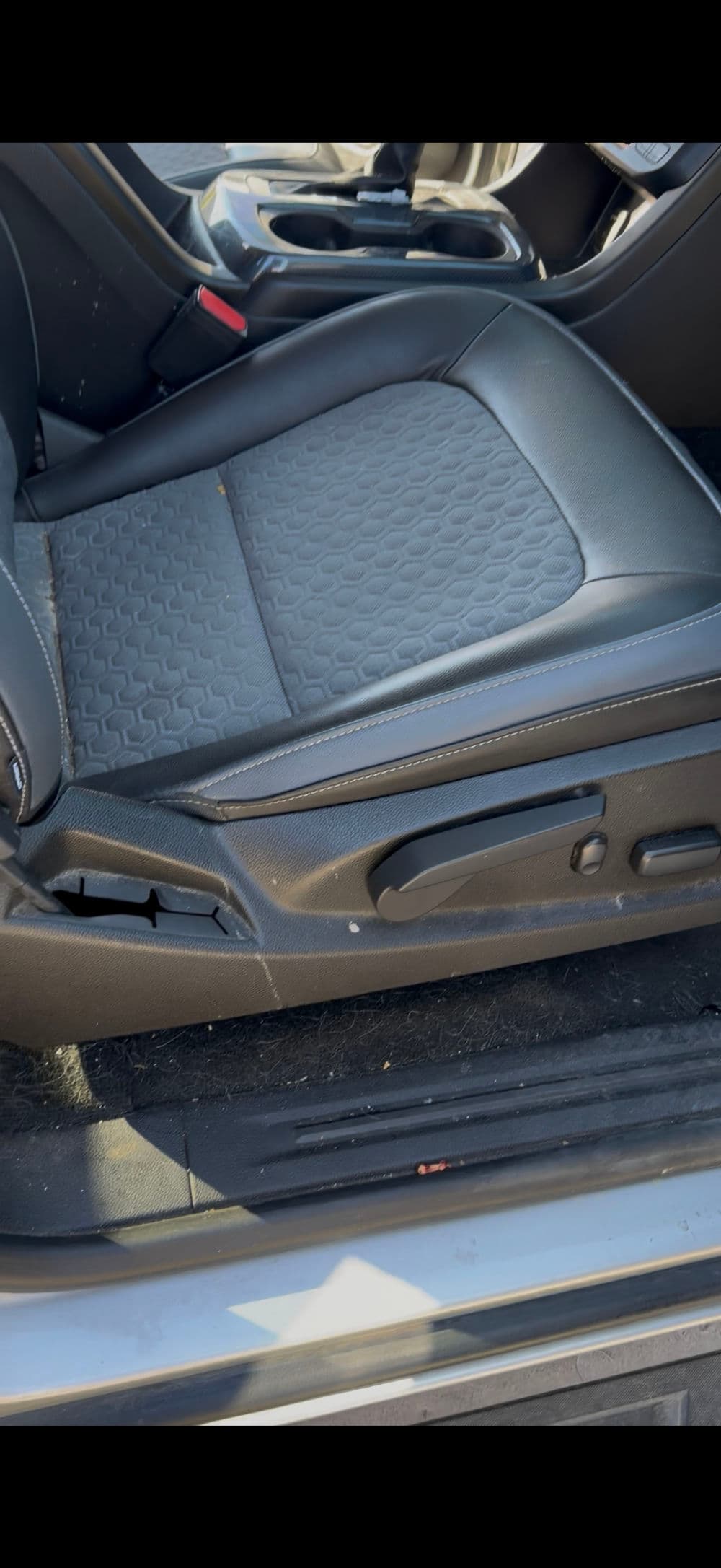 Black leather car seat interior with detailed stitching and clean design. Ideal for automotive reviews.