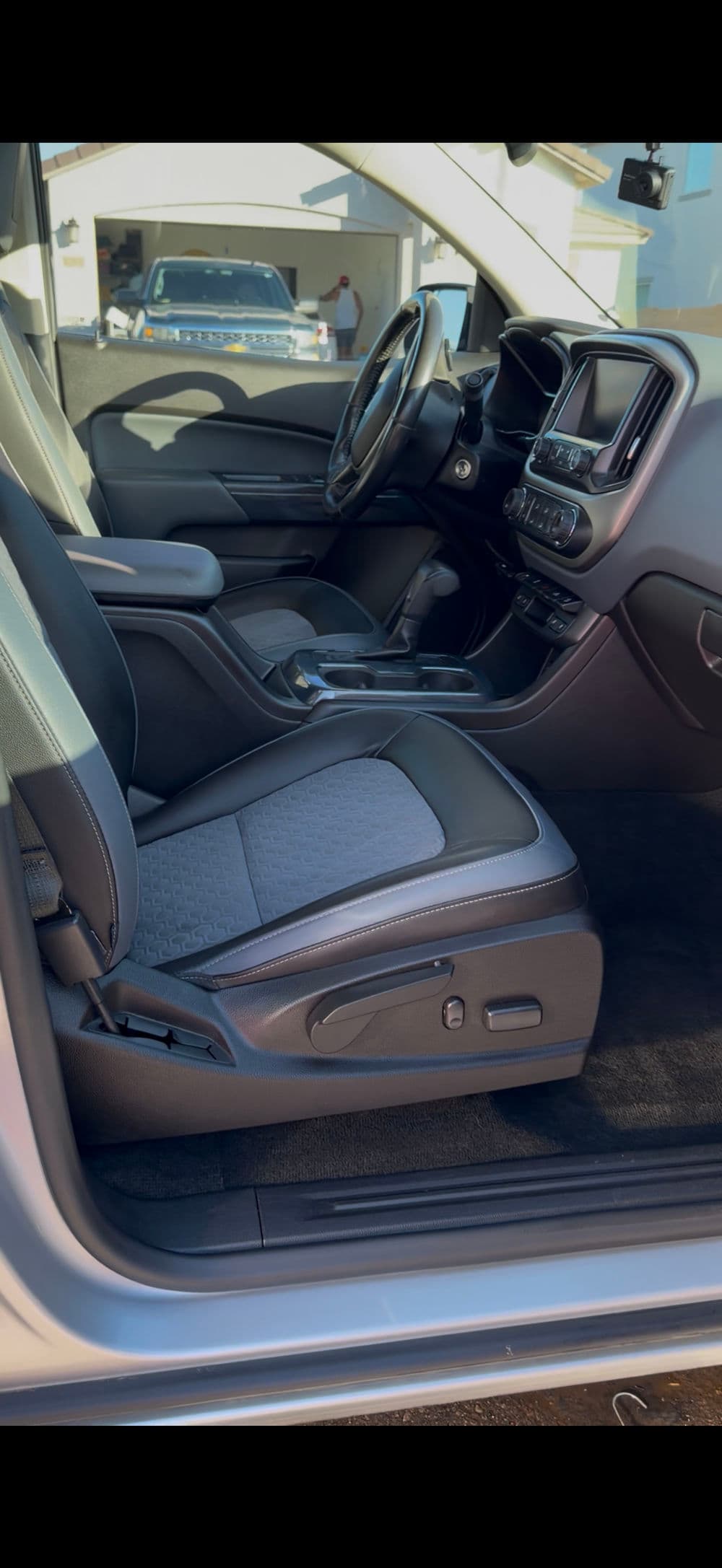 Modern car interior with leather seats, dashboard display, and spacious cabin design.