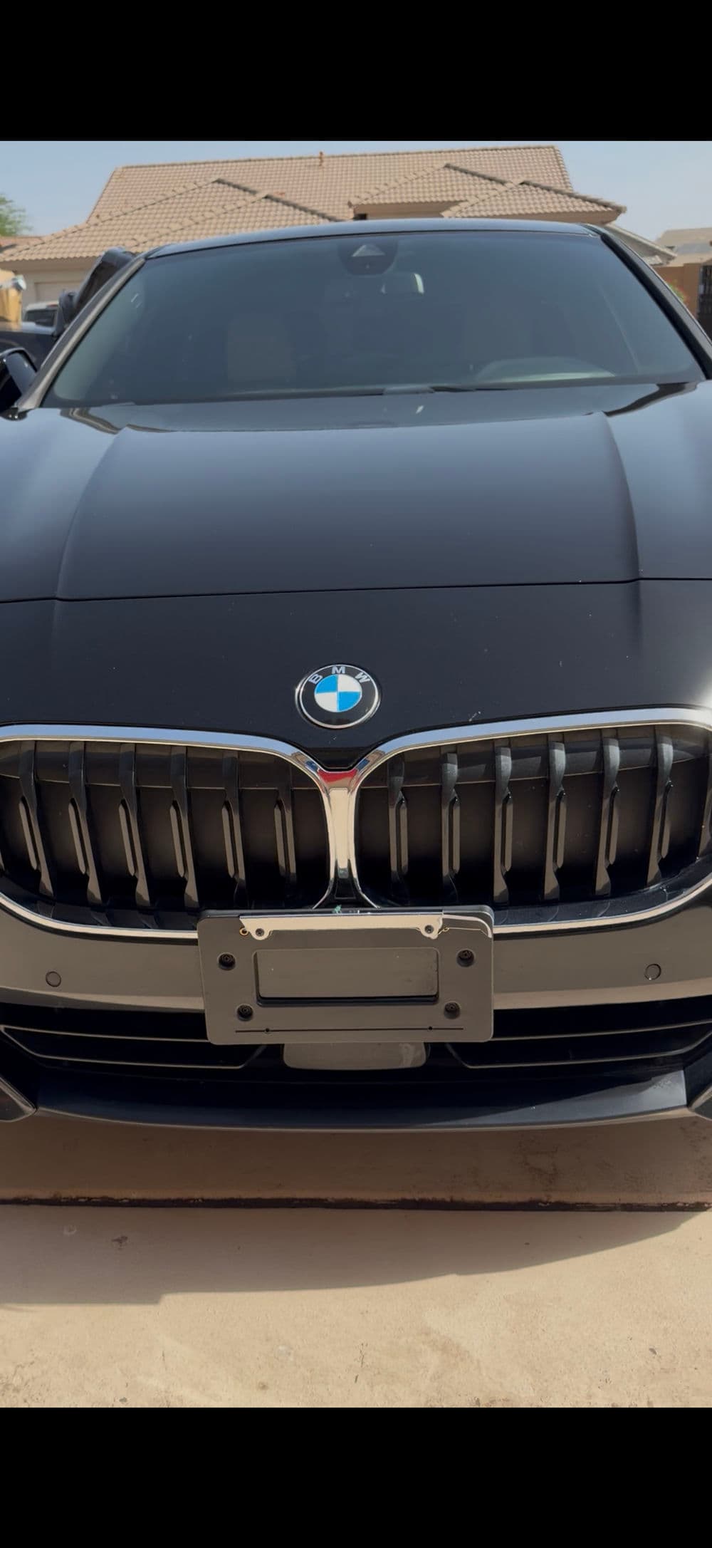 Black BMW with distinctive grille and emblem, showcasing luxury automotive design.