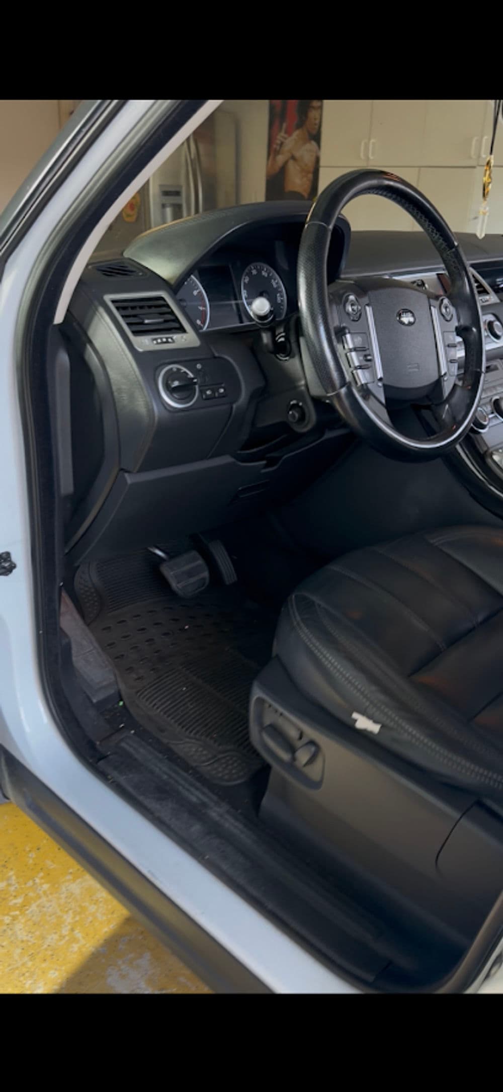 Interior of a car with black leather seats and modern dashboard controls.