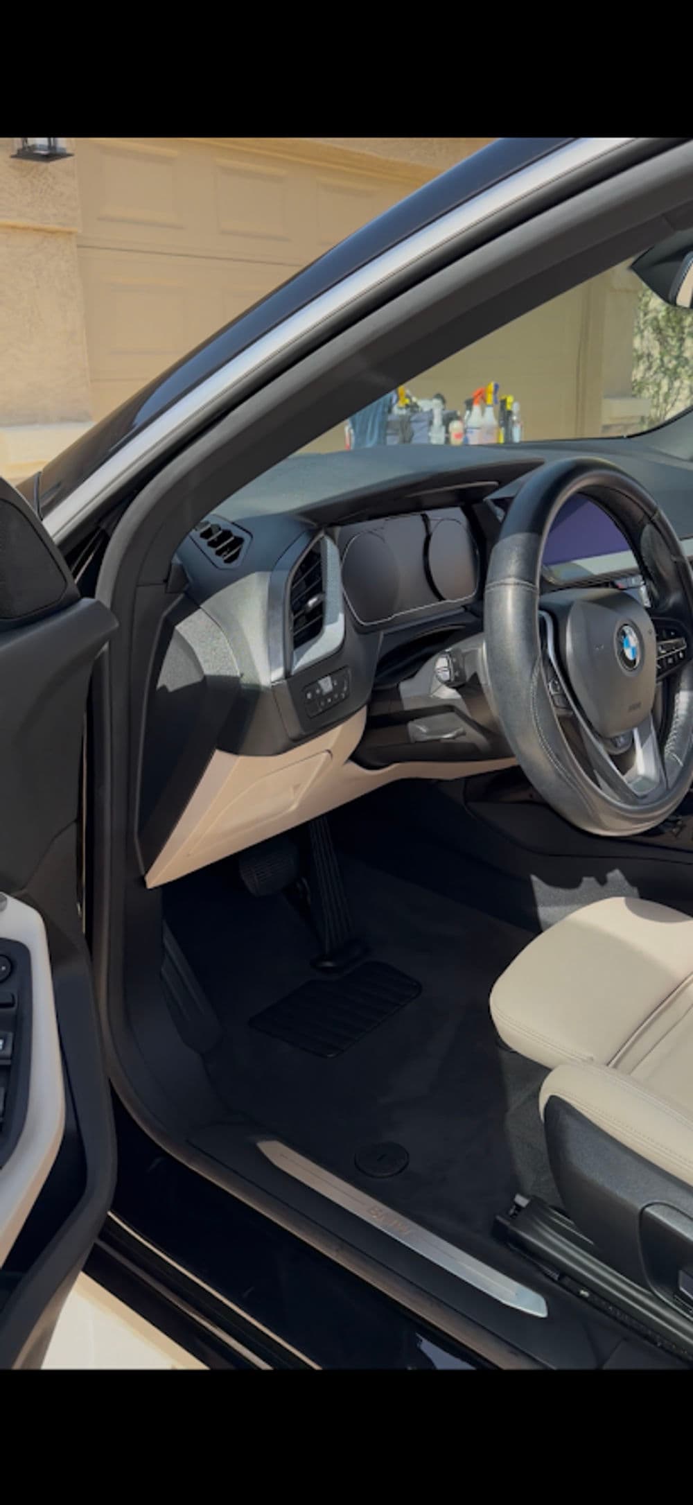BMW car interior showcasing steering wheel and dashboard with modern design elements.