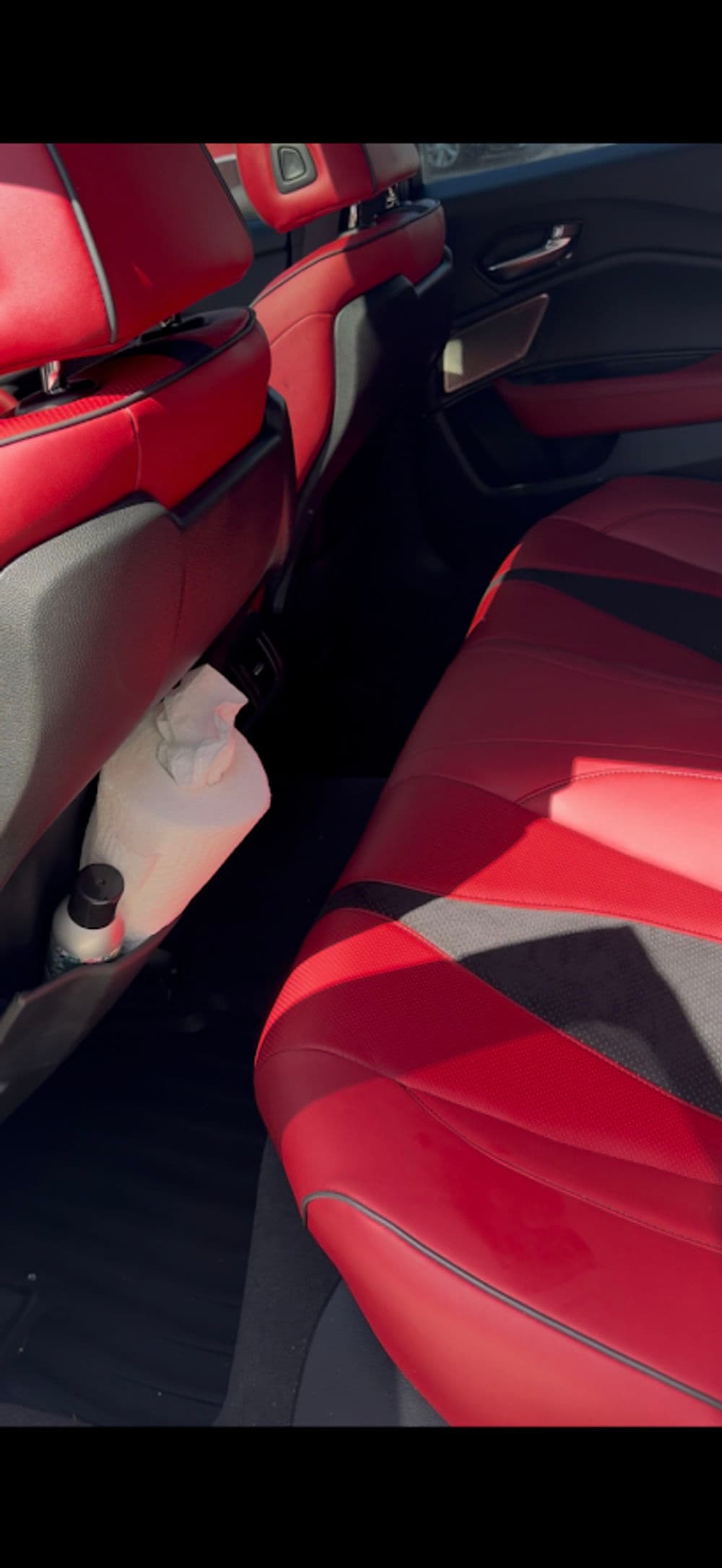 Red and black car interior featuring stylish seats and a sleek design.