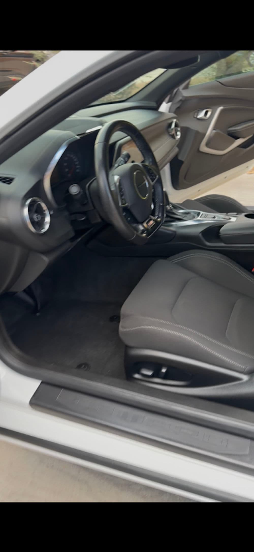 Interior of a luxury car showcasing leather seats and modern dashboard design.